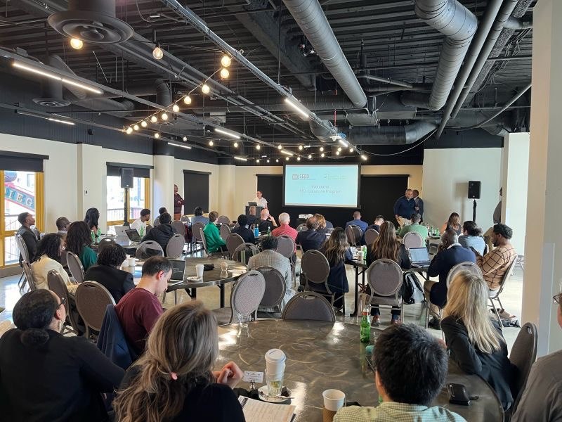 Audience attending a Bio-PrecisionAI Health conference presentation